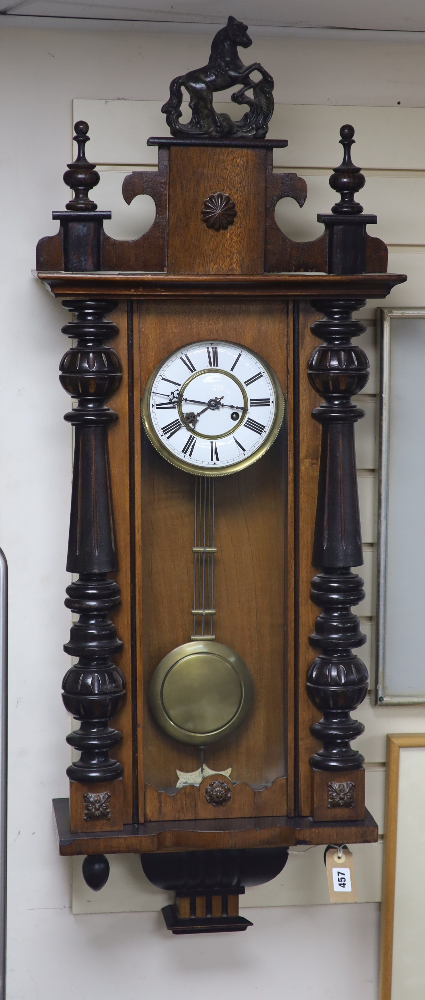 A 19th century Continental regulator in architectural walnut case, with key and gridiron pendulum, 116cm